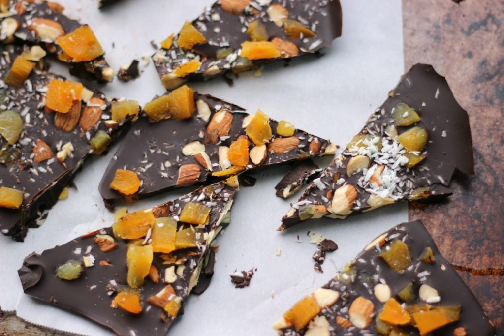 Dark Chocolate Apricot Bark broken into pieces on a sheet pan.