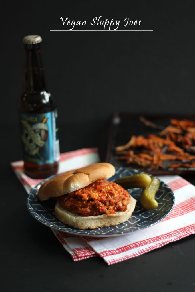 Vegan Sloppy Joes on a plate with a beer on the side. 