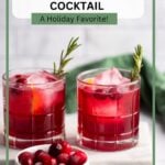 cranberry gin cocktail in glass garnished with rosemary.