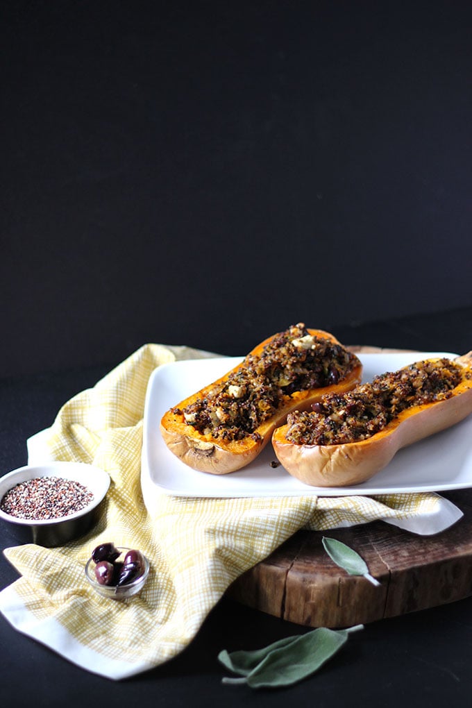 Vegetarian Stuffed Butternut Squash on a white plate with a black background. 