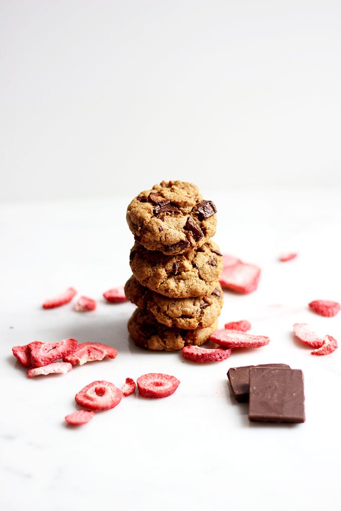 strawberry and chocolate cookies stacked on top of each other on a white background.