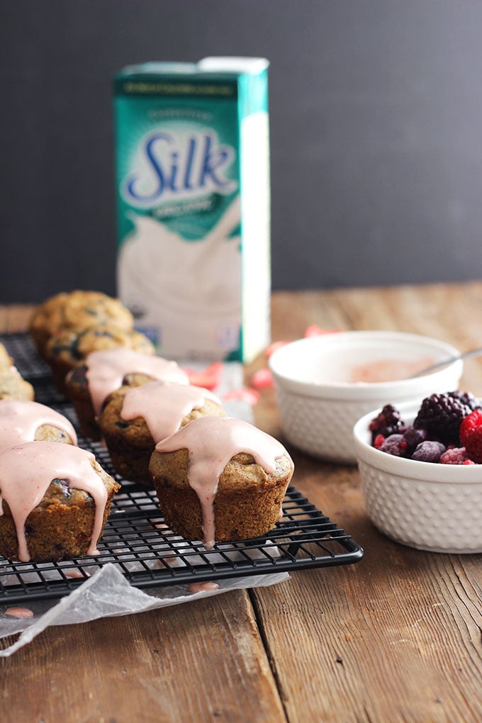 Vegan Berry Muffins with pink glaze on a cooling rack.