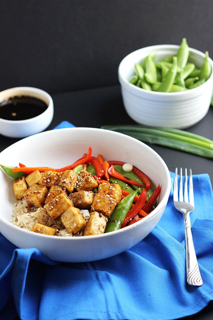 Vegan Tofu Teriyaki Bowl with a blue napkin on the side. 