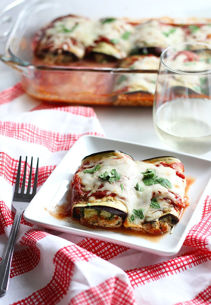 Eggplant Lasagna Rolls on a plate with a fork and napkin. 