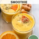 mango turmeric smoothie in glass garnished with hemp hearts.