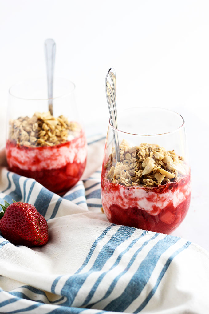 Strawberry Yogurt and PB Granola Parfait in glasses with spoon