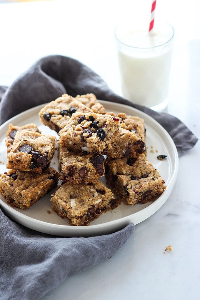 Vegan Berry Chocolate Chip Blondies cut into squares on a white plate. 