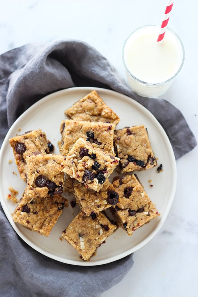 Vegan Berry Chocolate Chip Blondies cut into squares on a white plate. 