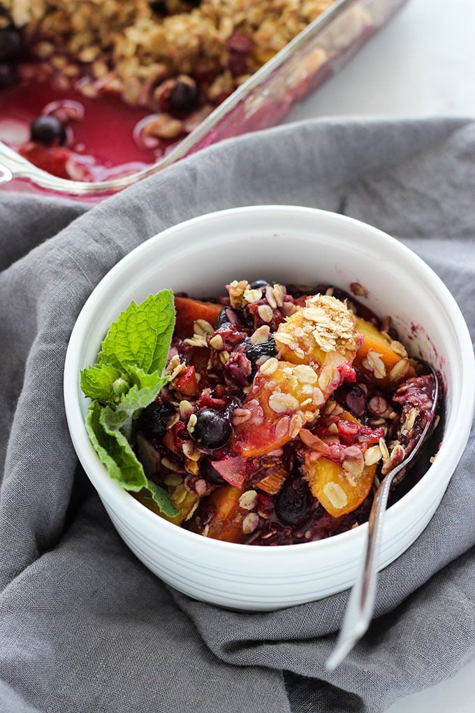 peach blueberry crisp in small bowl for serving. 