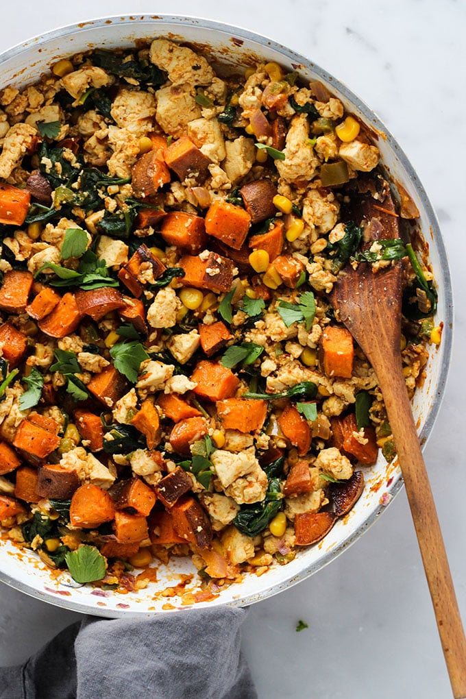 Chipotle Tofu and Sweet Potato recipe in metal skillet with wooden spoon