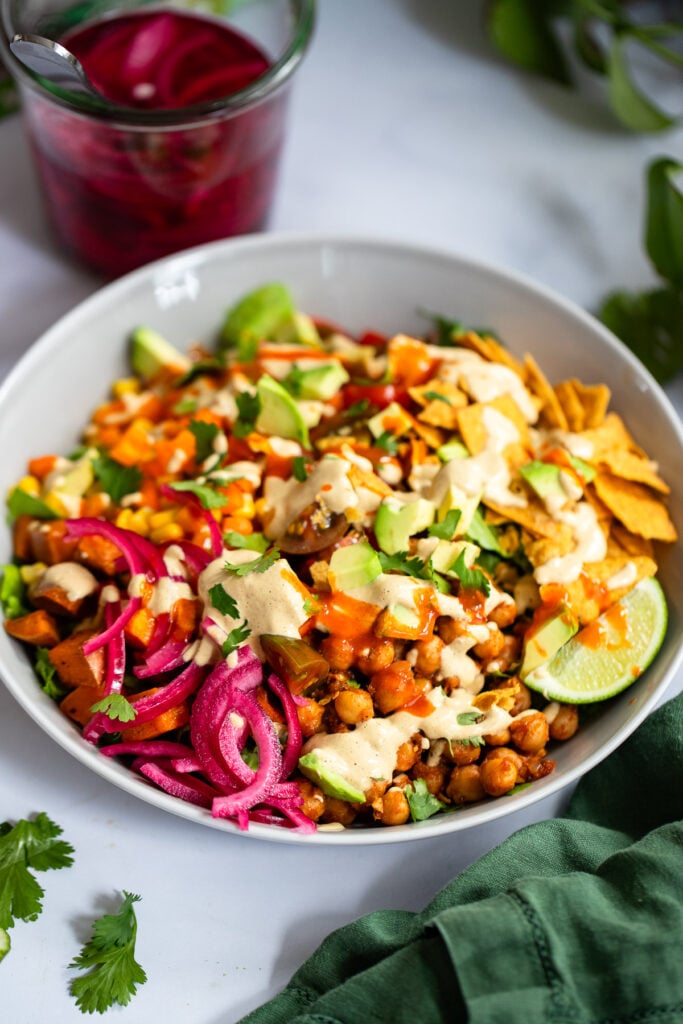 taco salad in bowl with dressing. 