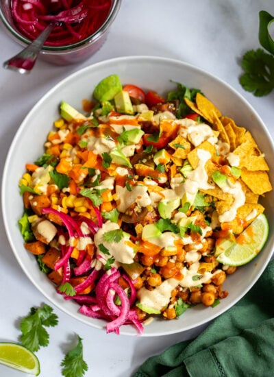 chickpea taco salad in a bowl topped with creamy cashew dressing.