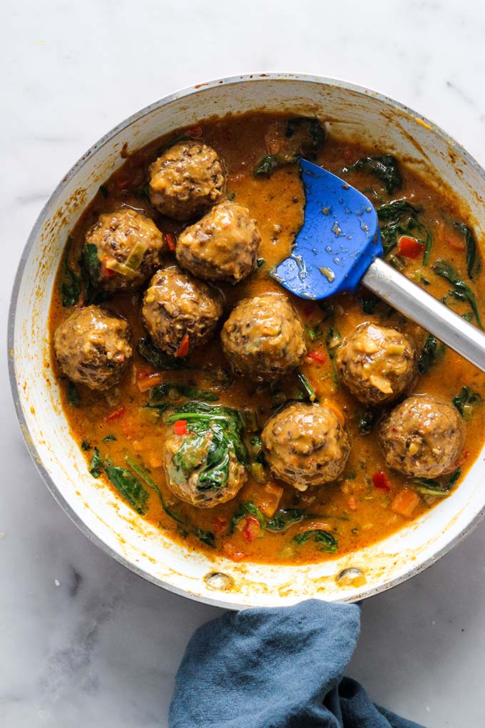 lentil meatballs with curry sauce in skillet