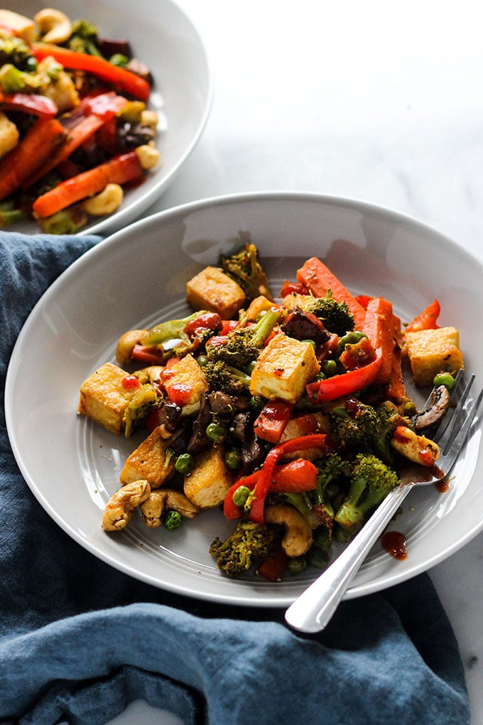 Tofu Vegetable Stir Fry in a shallow bowl with a fork.