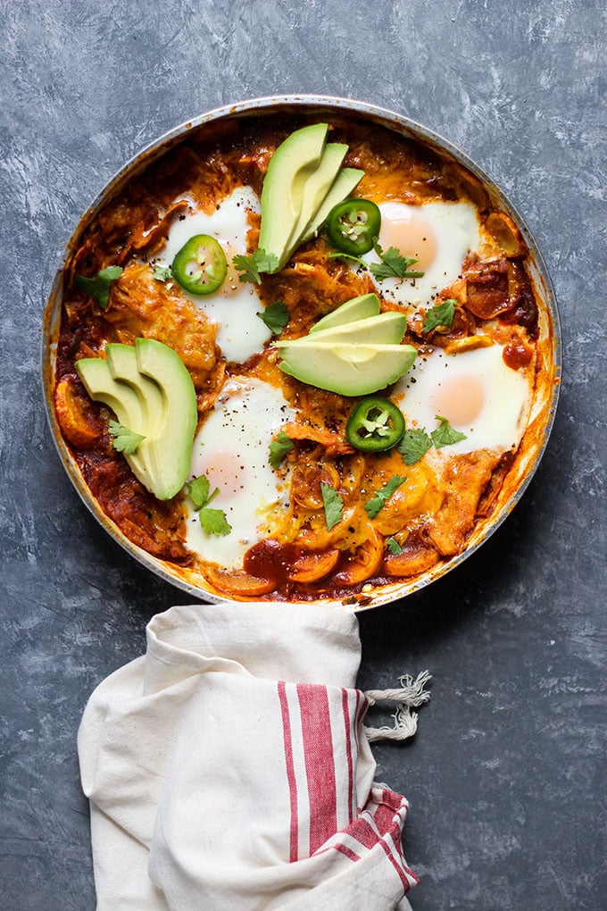 Skillet Chilaquiles with Eggs topped with avocado and cilantro.