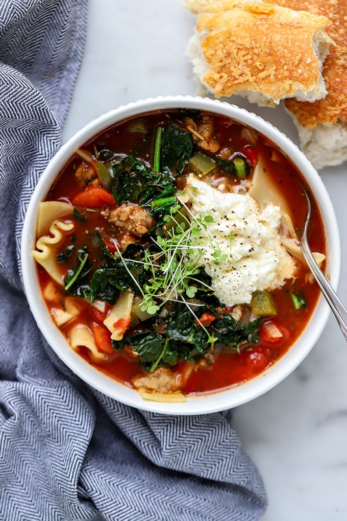 Vegetarian Lasagna Soup in white bowl with blue napkin