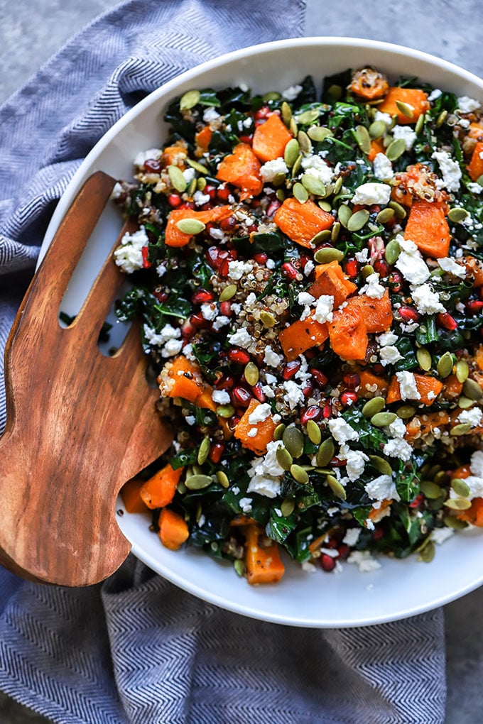 Winter Kale Salad | A healthy addition to your holiday gatherings! Made with roasted butternut squash, pomegranate, and goat cheese.