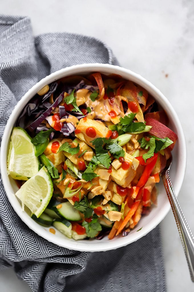 Soba Noodles with Peanut Sauce in bowl with cilantro and lime.