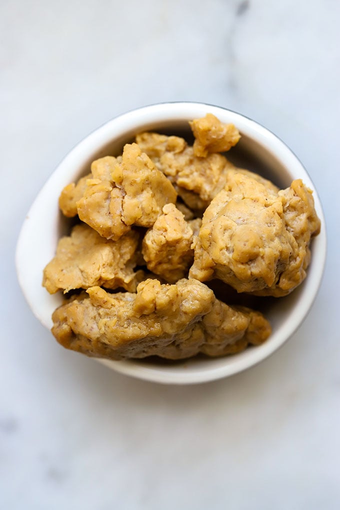 Crumbled seitan in white bowl.