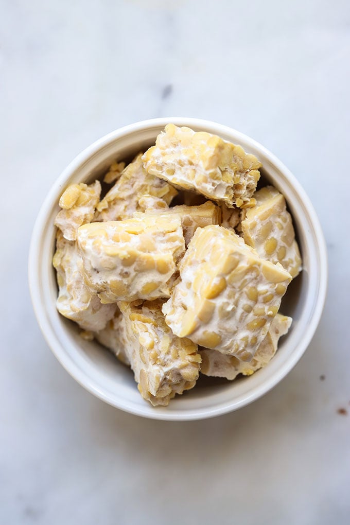 Cubed tempeh in white bowl.