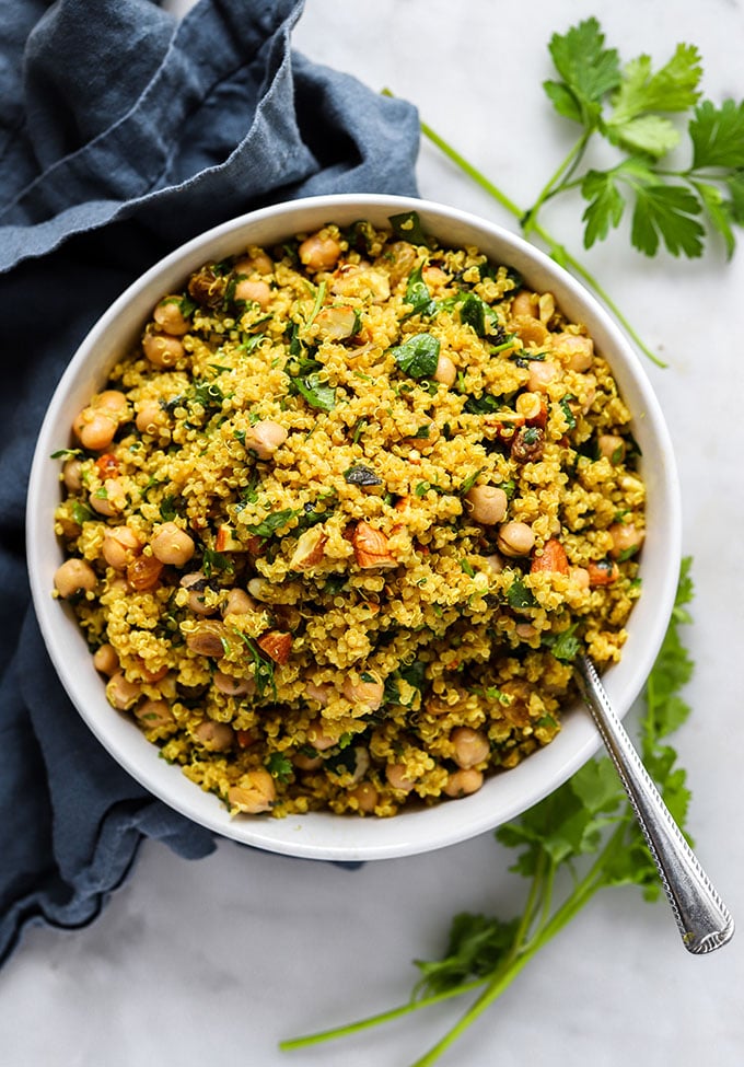 Overhead shot of Simple Curry Spiced Quinoa in bowl with blue napkin.