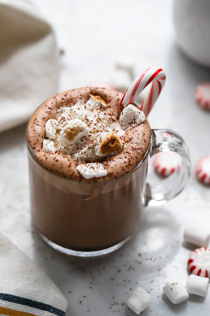 peppermint hot chocolate garnished with marshmallows and candy cane