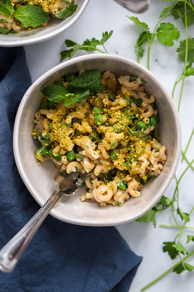 creamy vegan pasta in bowl garnished with mint.