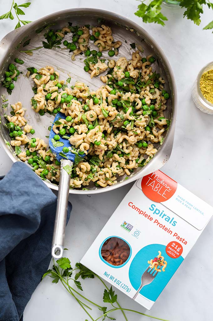 creamy vegan pasta with peas and mint in skillet. 