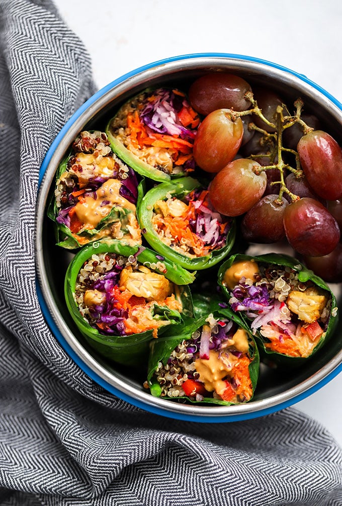 tempeh peanut sauce collard green wraps in a round bento box.