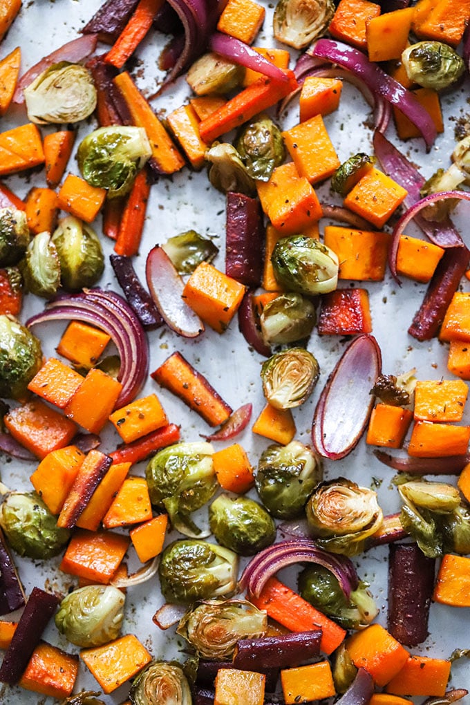 close up balsamic herb roasted vegetables on sheet pan