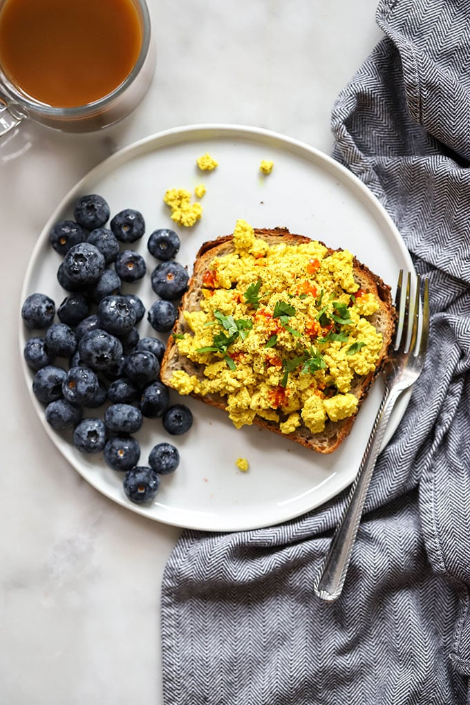 easy vegan tofu scramble on toast on white plate with fork