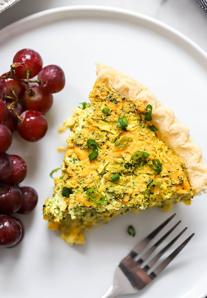 slice vegan broccoli cheddar quiche on white plate