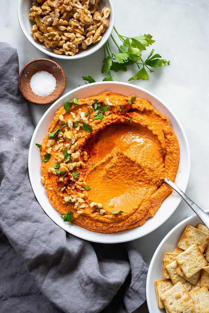 vegan roasted red pepper dip in white bowl.