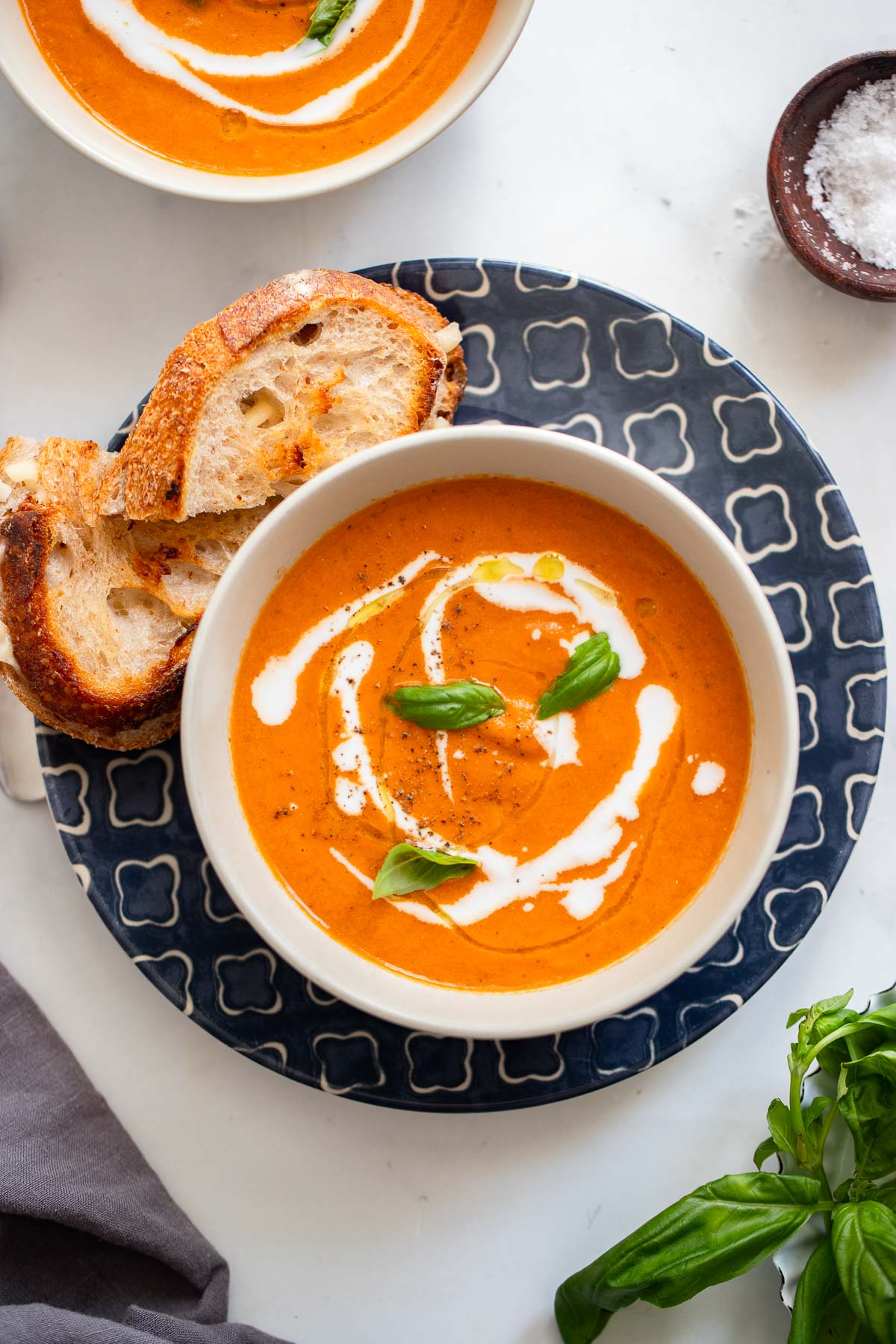 oven roasted tomato soup garnished with fresh basil and coconut milk.