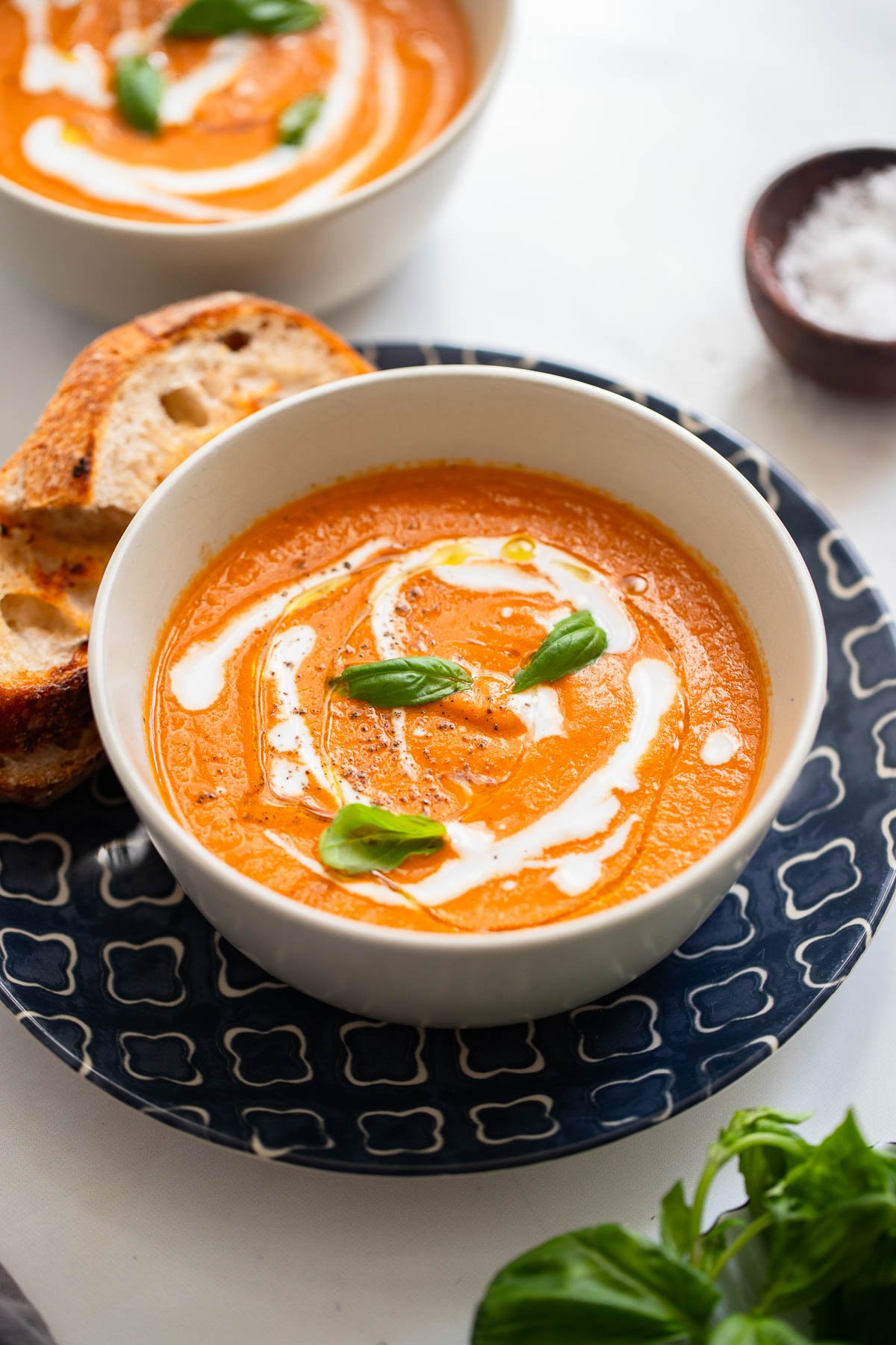 roasted tomato basil soup in a bowl garnished with fresh basil.