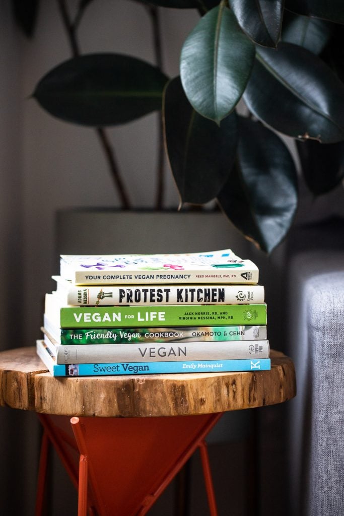 photo of books on Veganism in a stack on a small table.
