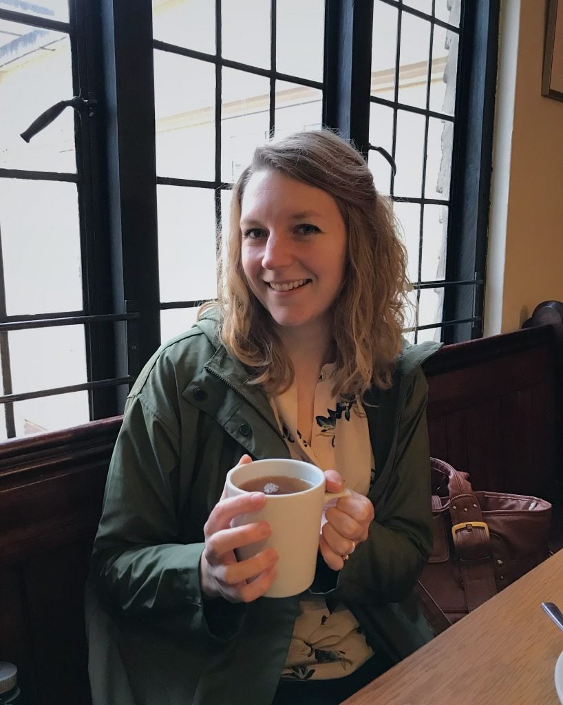 photo of Deb holding a cup of tea.