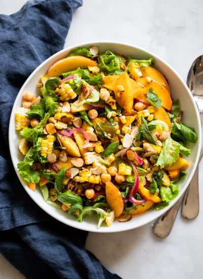 Summer peach salad with chickpeas, almonds, corn, and red onion