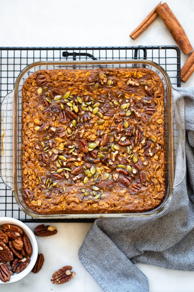 baked pumpkin oatmeal in dish with pecans.