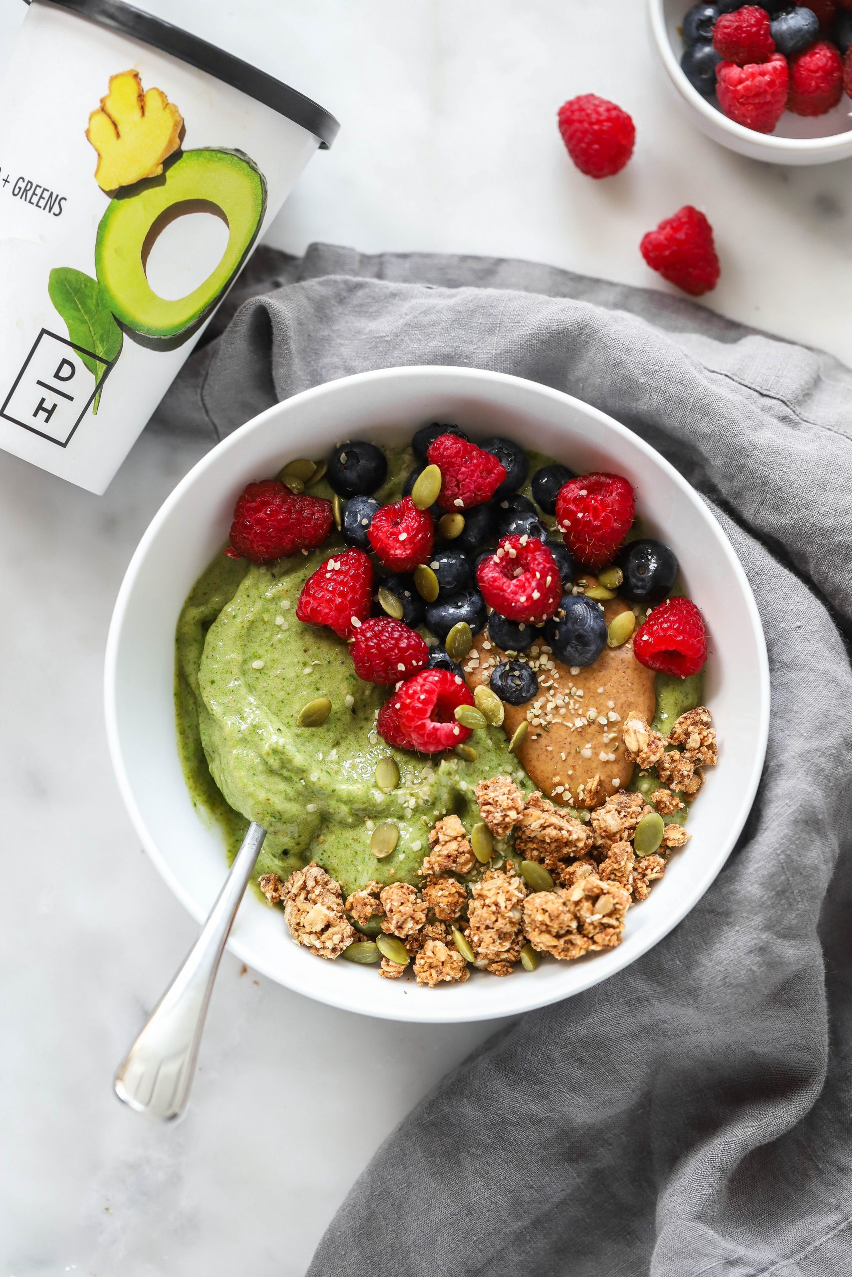 daily harvest smoothie bowl garnished with granola and berries.