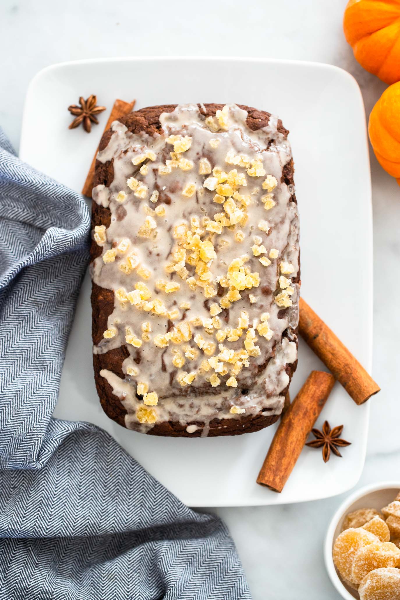 vegan pumpkin gingerbread with glaze and candied ginger.