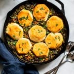 vegan lentil pot pie with biscuit topping in cast iron skillet.