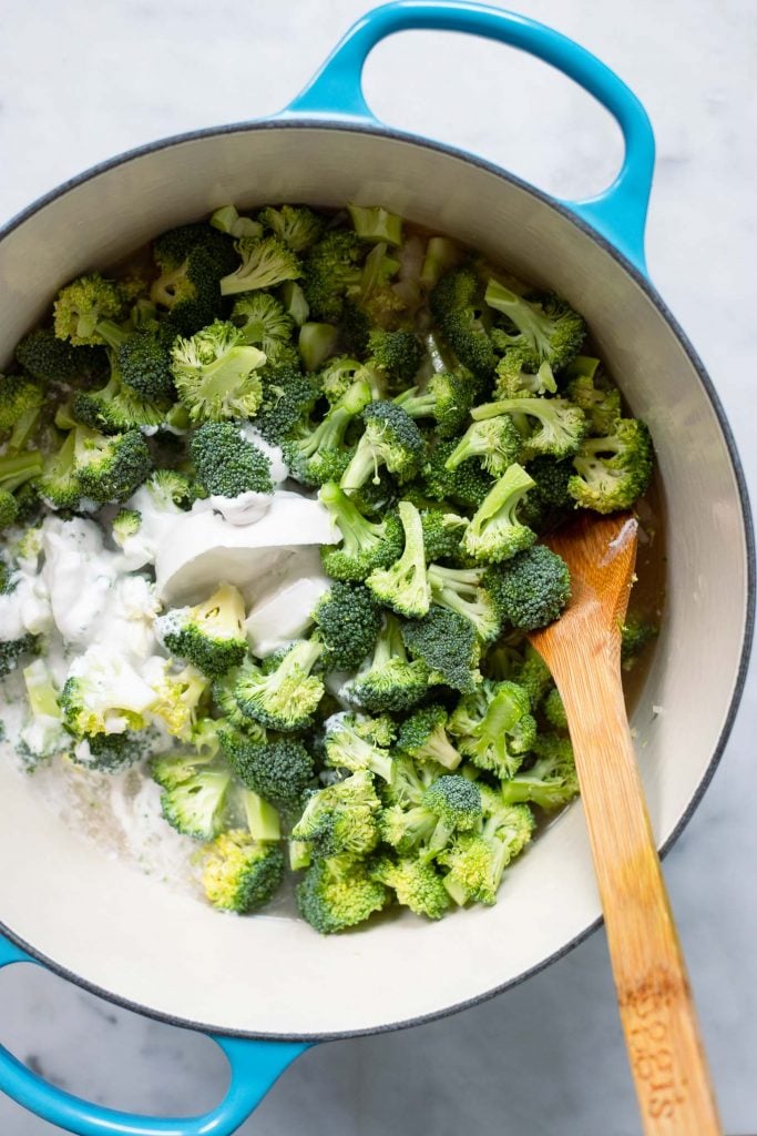 Stir the broccoli and coconut milk into the large stock pot and cook. 