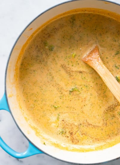 finished broccoli cheddar soup in dutch oven with spoon. 