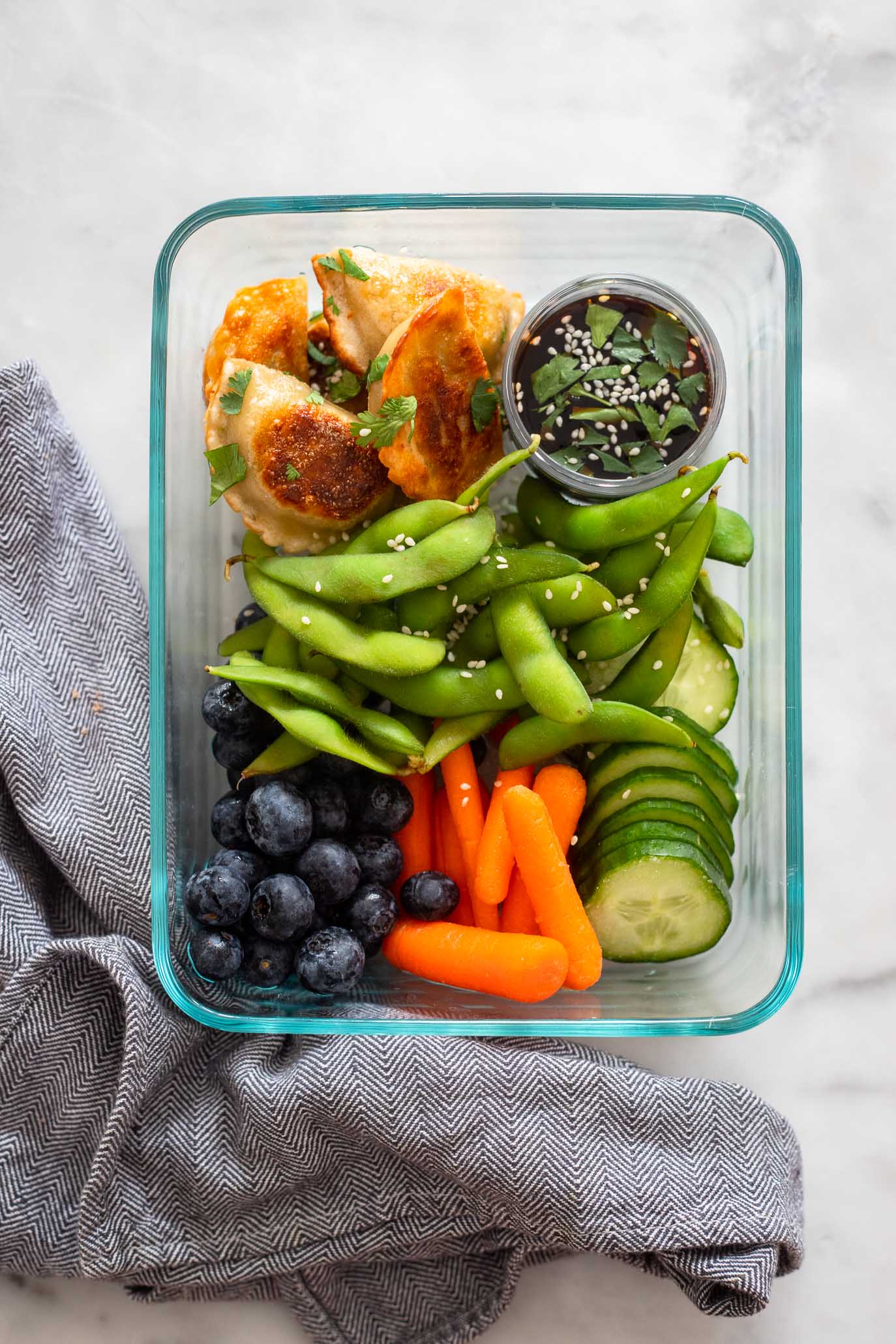 healthy vegan lunch ideas box with edamame and veggies.