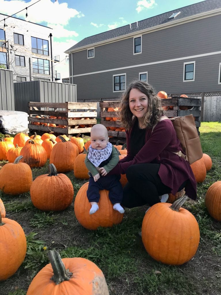 Mom with baby at pumpkin patch