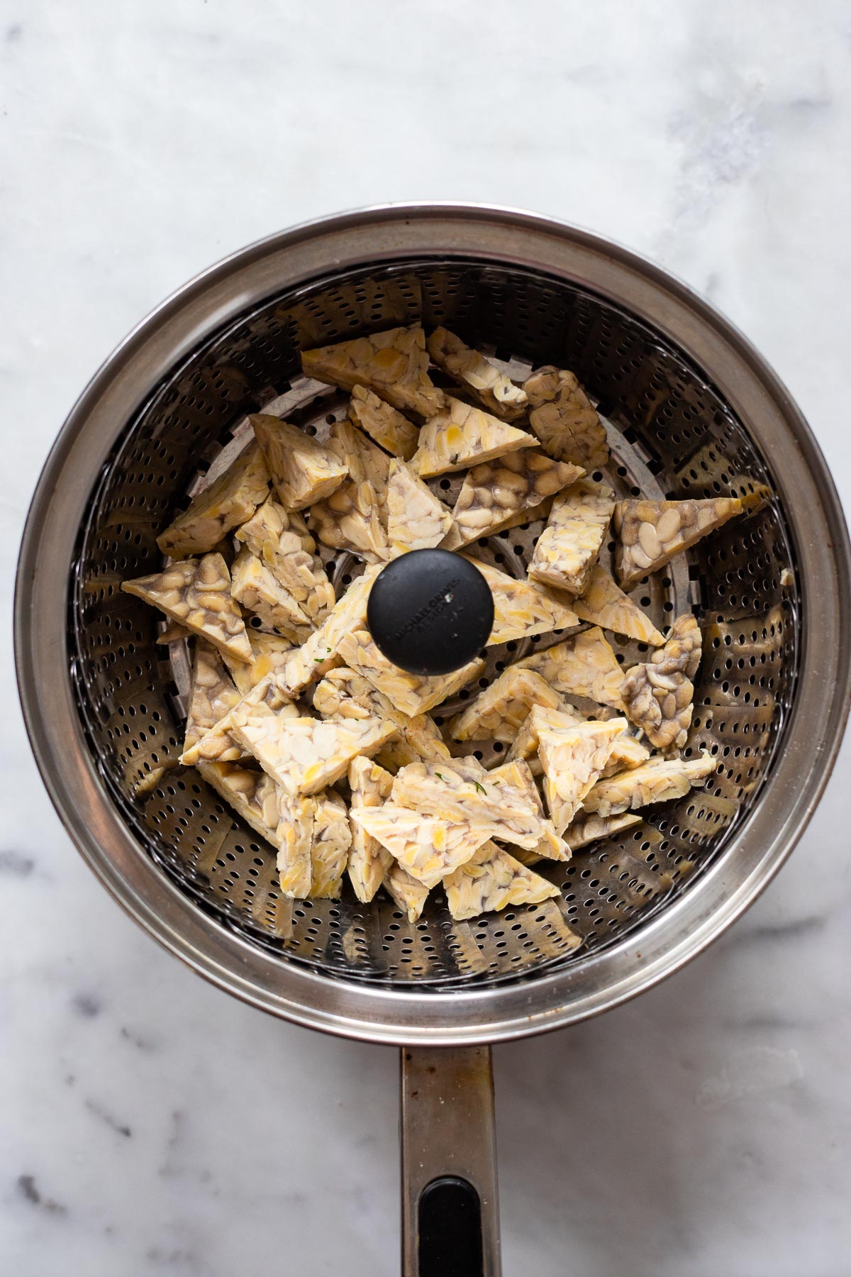 add chopped tempe to steamer basket and steam for up to 5 minutes.