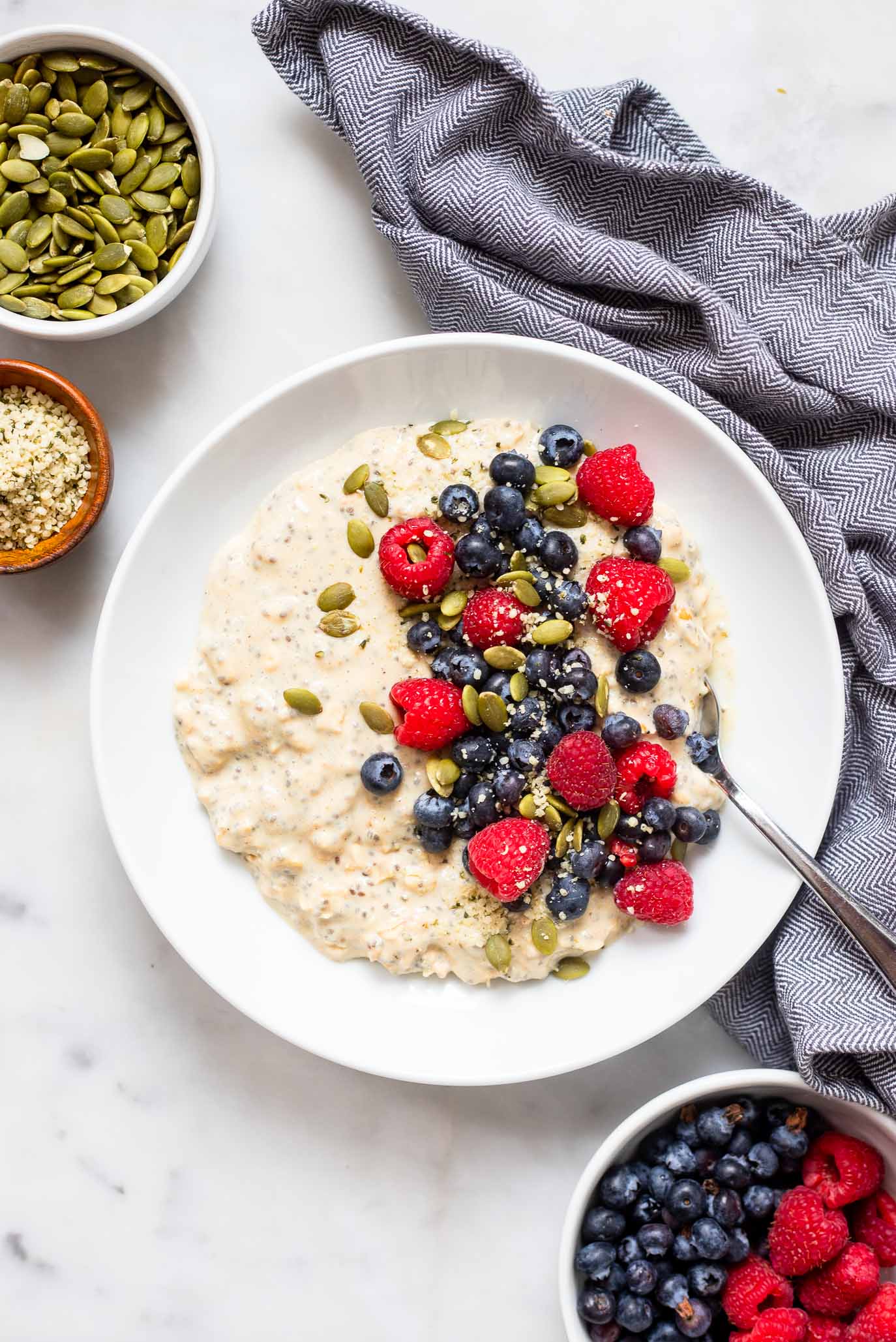 vegan protein overnight oats in bowl with fresh berries.