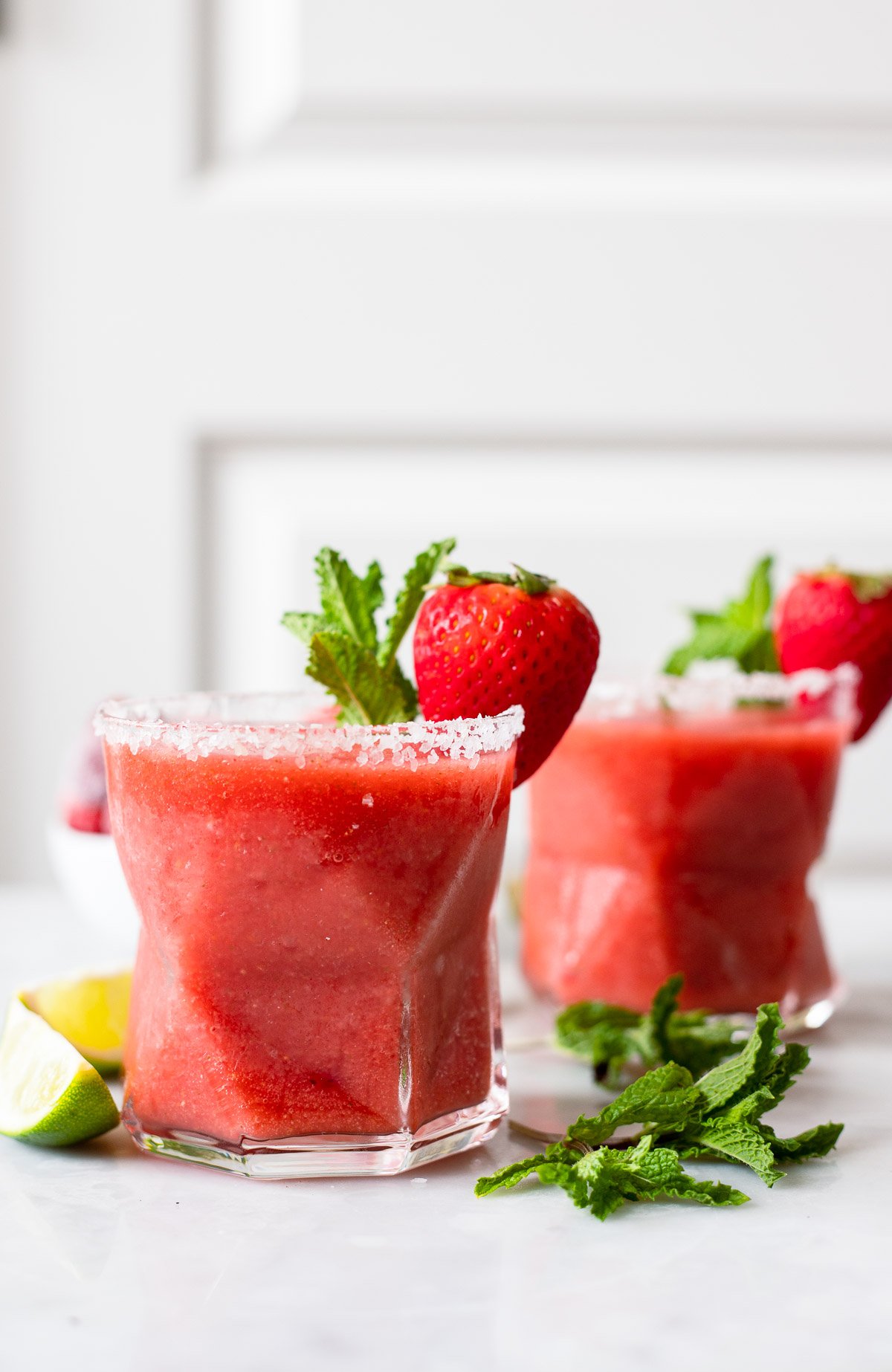 strawberry mint margarita in salt rimmed glass.