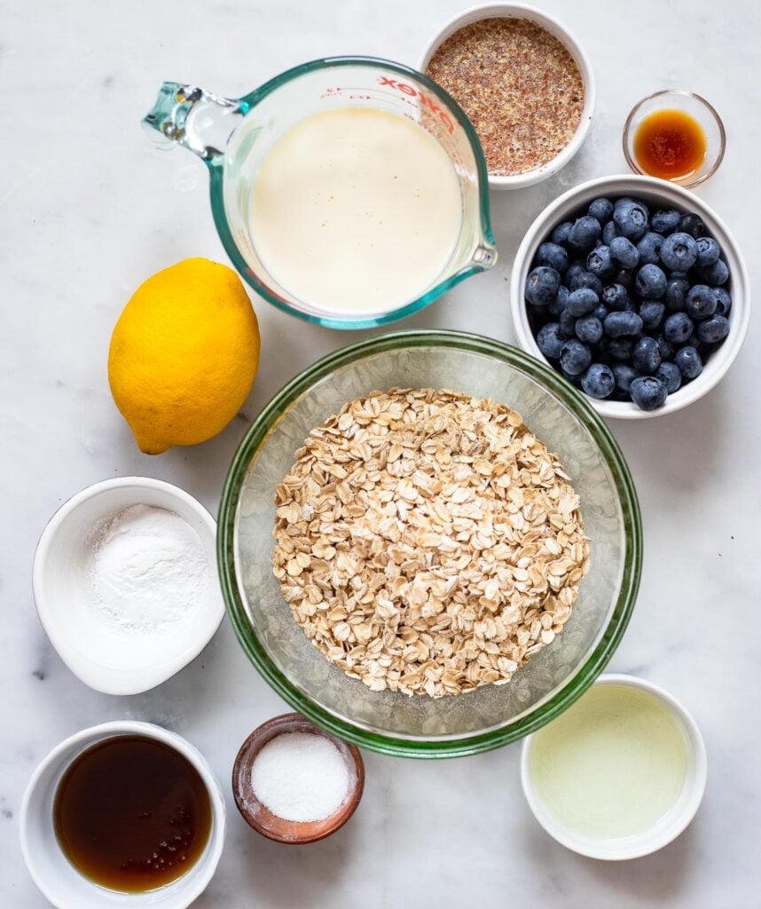 vegan lemon blueberry baked oatmeal recipe ingredients in small bowls. 